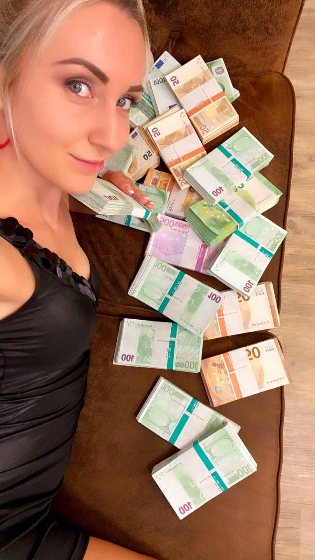 Geldherrin mit Geldscheinen auf Couch